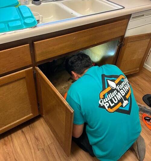 plumber fixing a sink