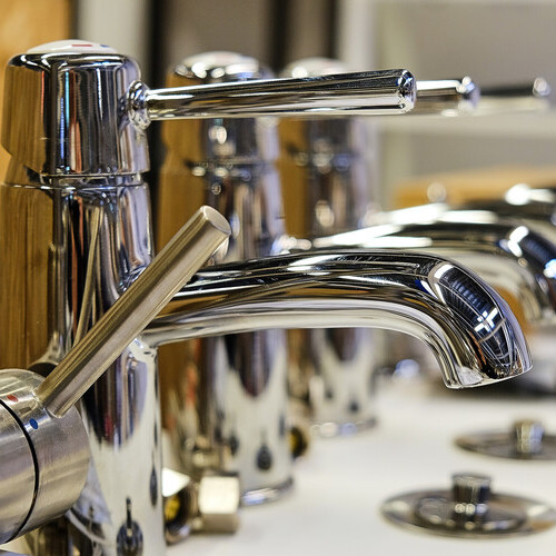 a row of commercial faucets