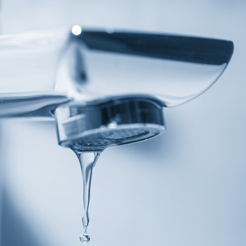 a drip coming from a water faucet