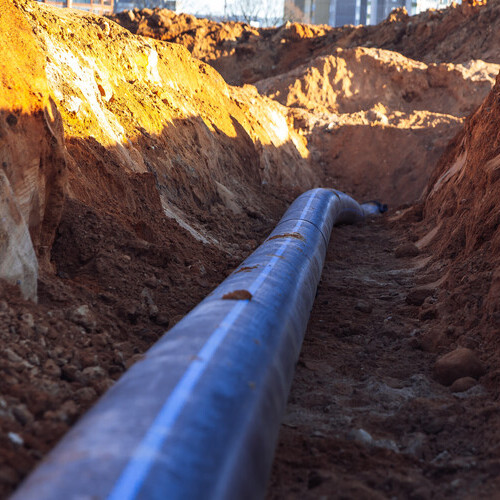 a plastic pipe in a trench
